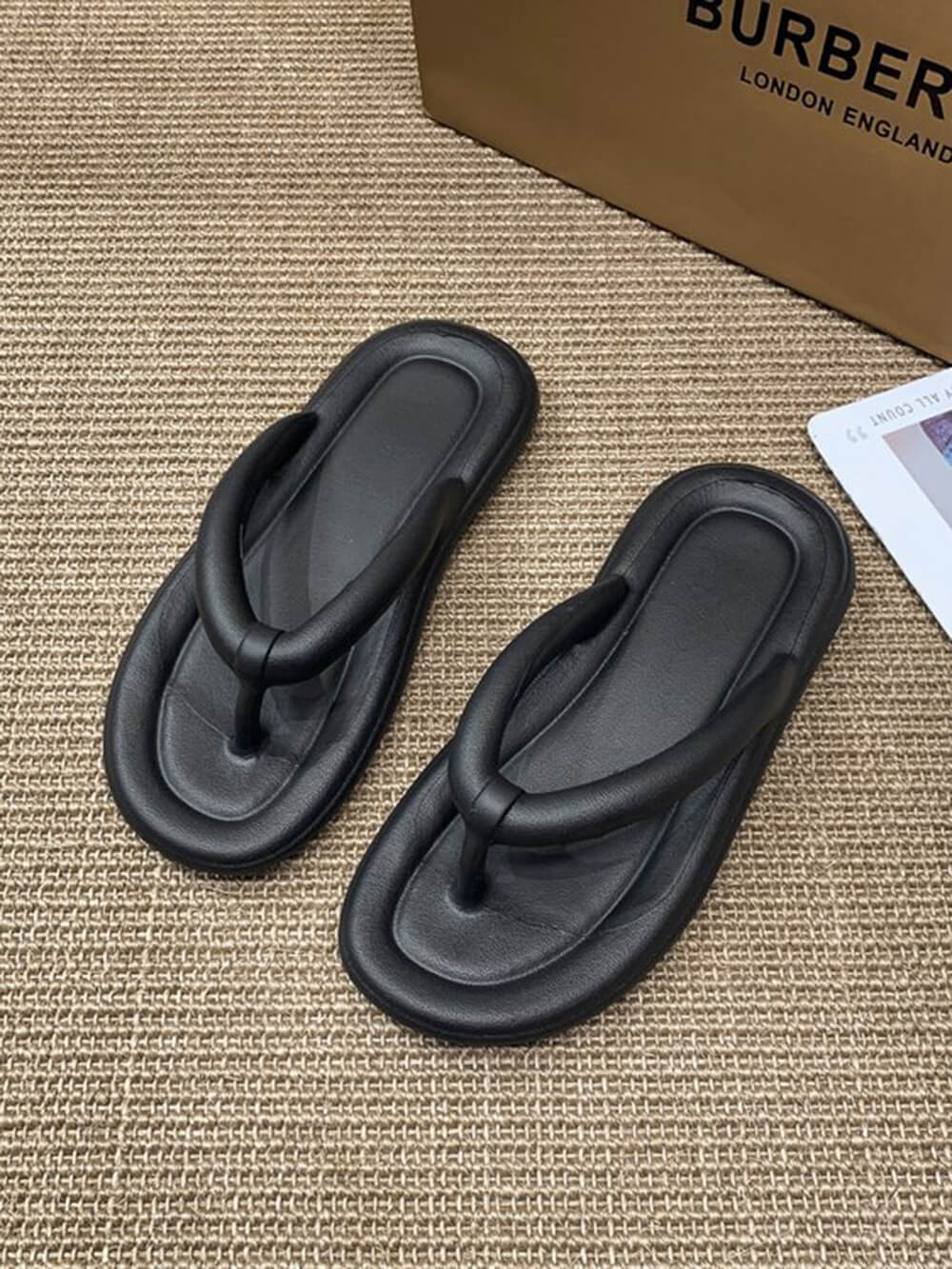 Black EVA foam flip flops with chunky platform sole and cushioned thong straps