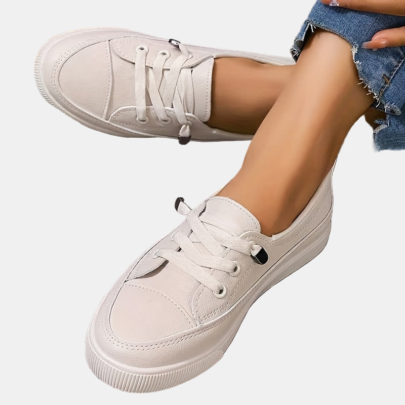 Women’s cream chunky platform lace-up sneakers in faux leather, close side view on feet.