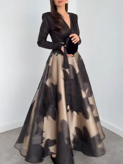 Black organza maxi dress with long sleeves and V-neck; full A-line skirt in floral print