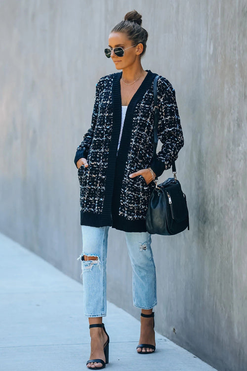 Navy speckled knit cardigan worn open over light jeans, long sleeves