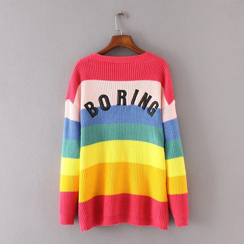 Rainbow striped knit sweater with crew back and "BORING" graphic