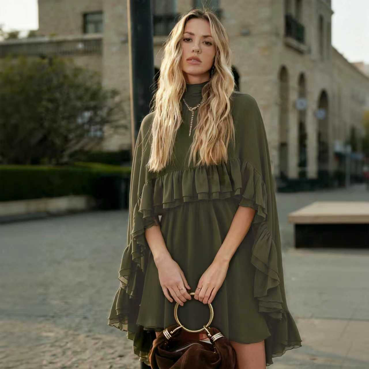 Olive chiffon mini dress with high neck, cape sleeves, and tiered ruffle skirt
