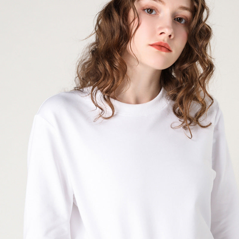 White round-neck cotton pullover sweater on model, long sleeves, loose fit