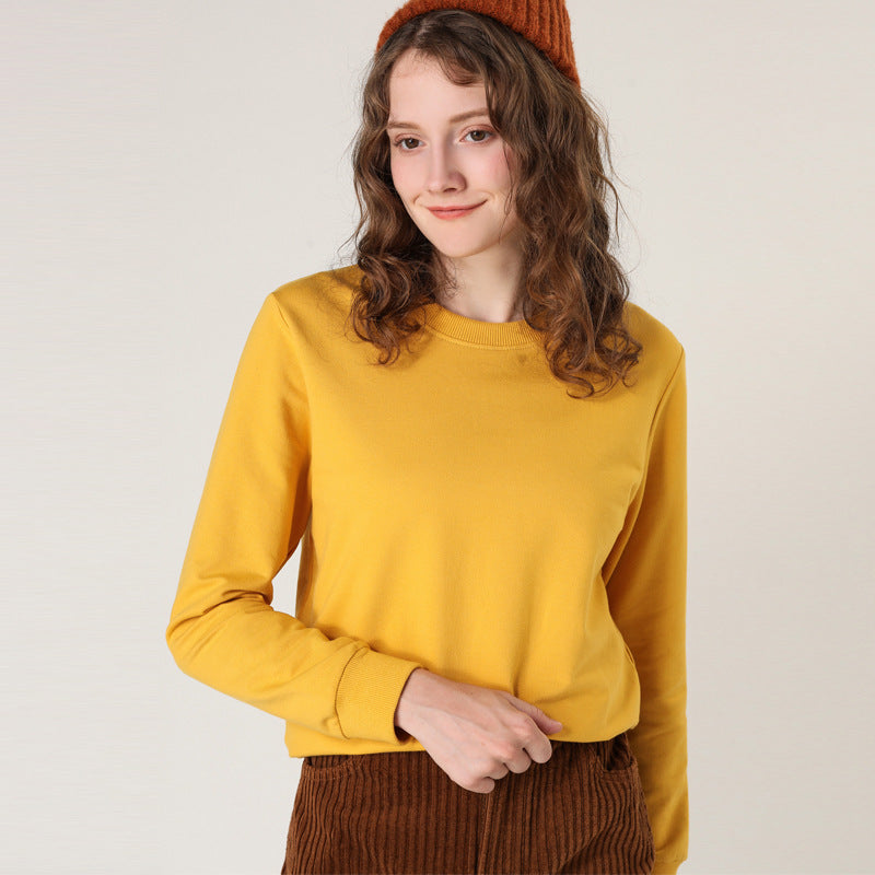 Mustard yellow round-neck cotton pullover sweater on model, long sleeves