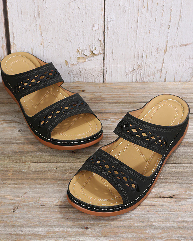 Black faux-leather flatform slide sandals with embroidered cutout strap detail