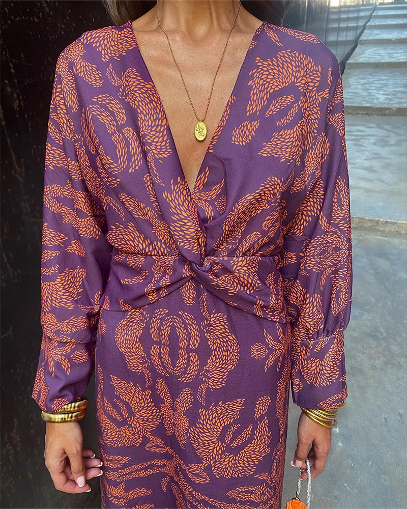 Purple midi wrap-style dress, deep V-neck, long sleeves, orange botanical print