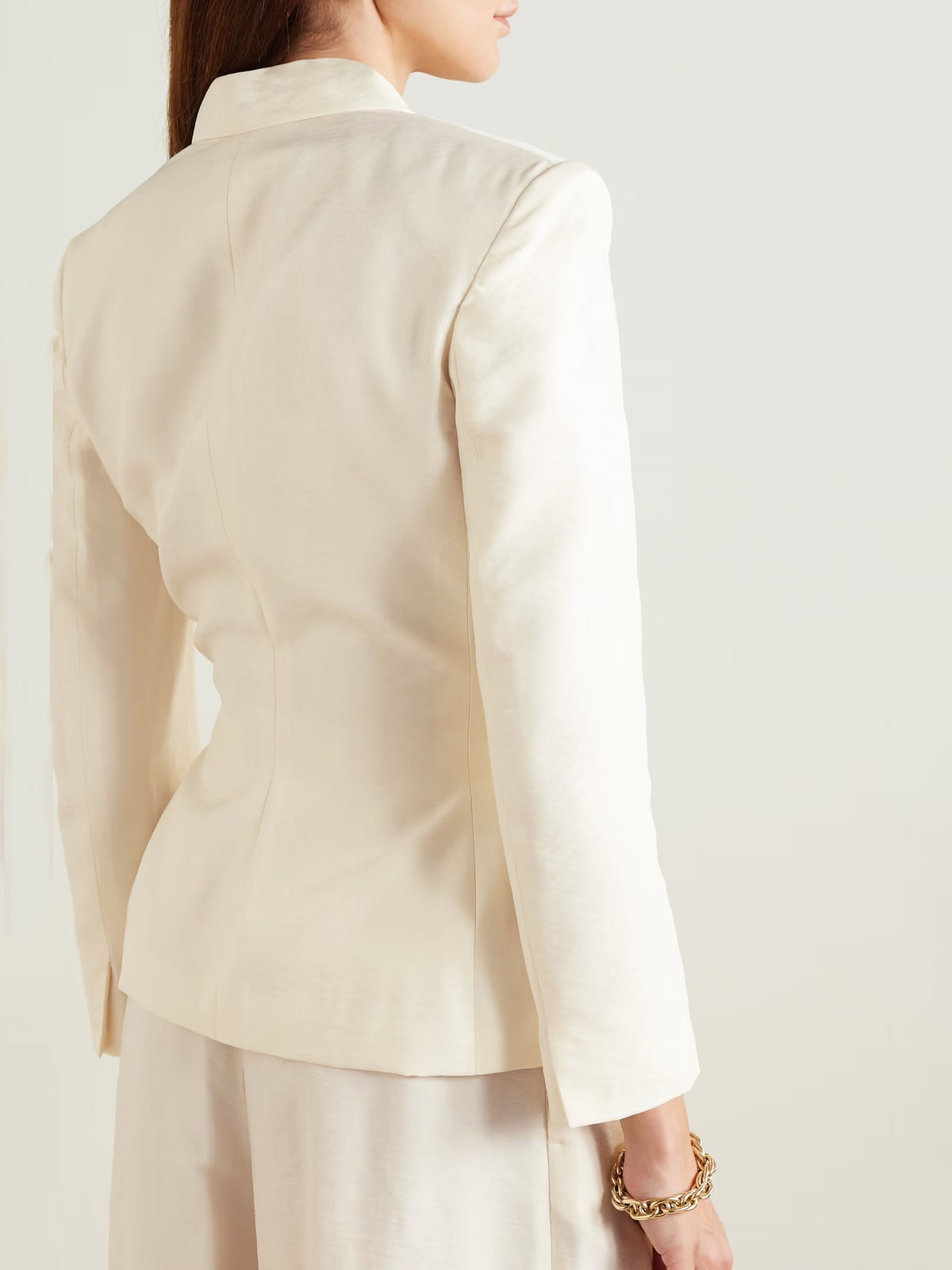 Cream fitted blazer back view with structured shoulders and buttoned seams