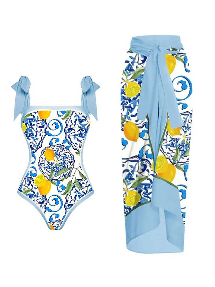 Light blue one-piece swimsuit with tie straps and blue-yellow graphic print; wrap sarong set
