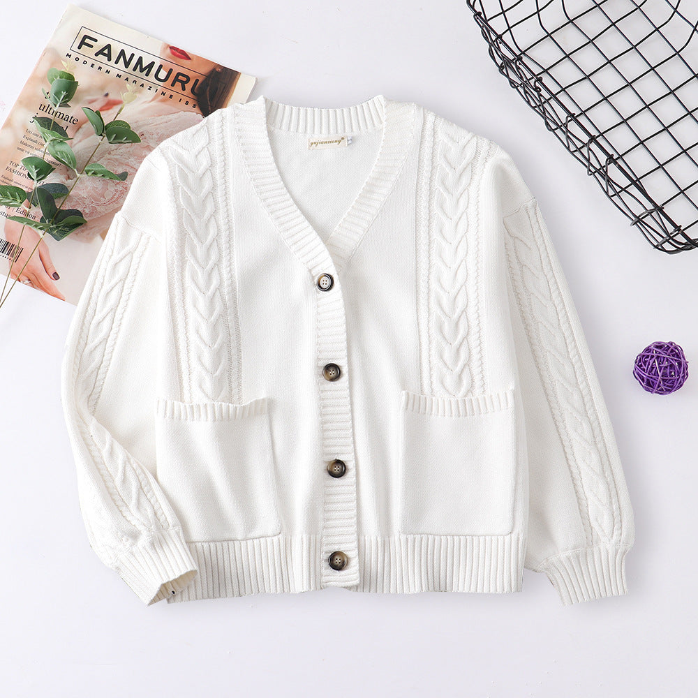 Women’s cable knit cardigan in white with V-neck button front and patch pockets