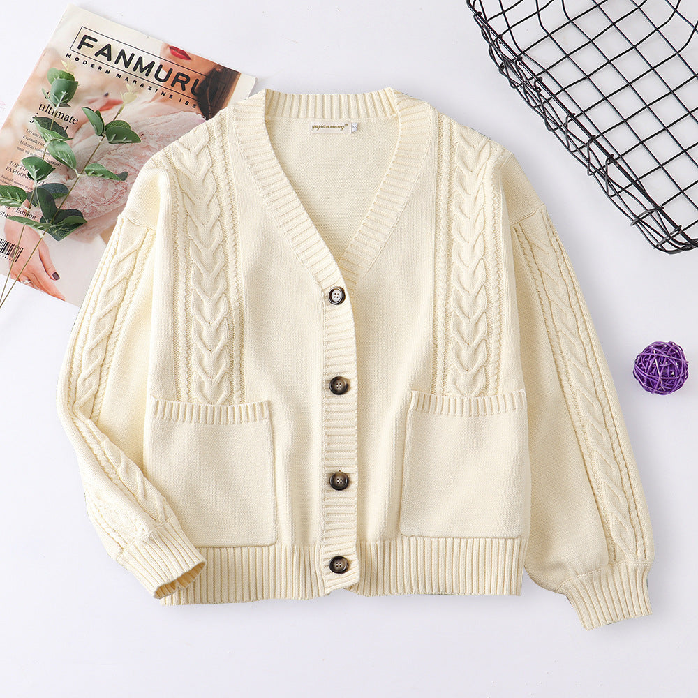 Women’s cable knit cardigan in cream with V-neck button front and patch pockets