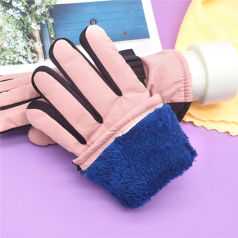 Thick winter ski gloves in pink with blue fleece cuff lining and dark wrist strap