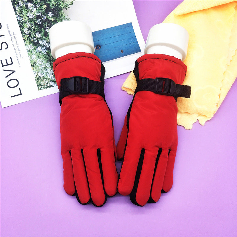 Thick winter ski gloves in red with black wrist strap and padded palm protection