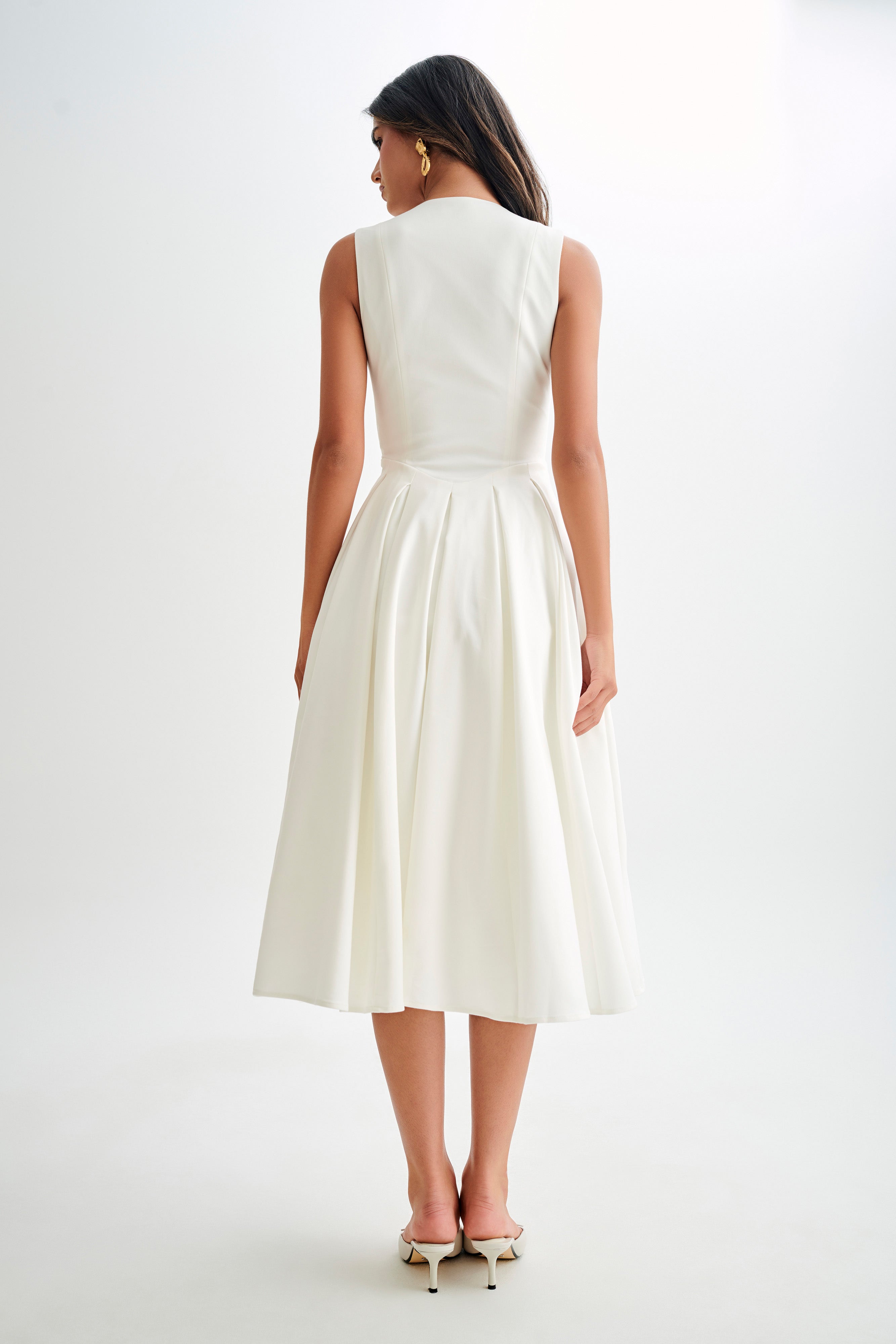 White satin A-line midi dress, sleeveless back view with gathered waist pleats