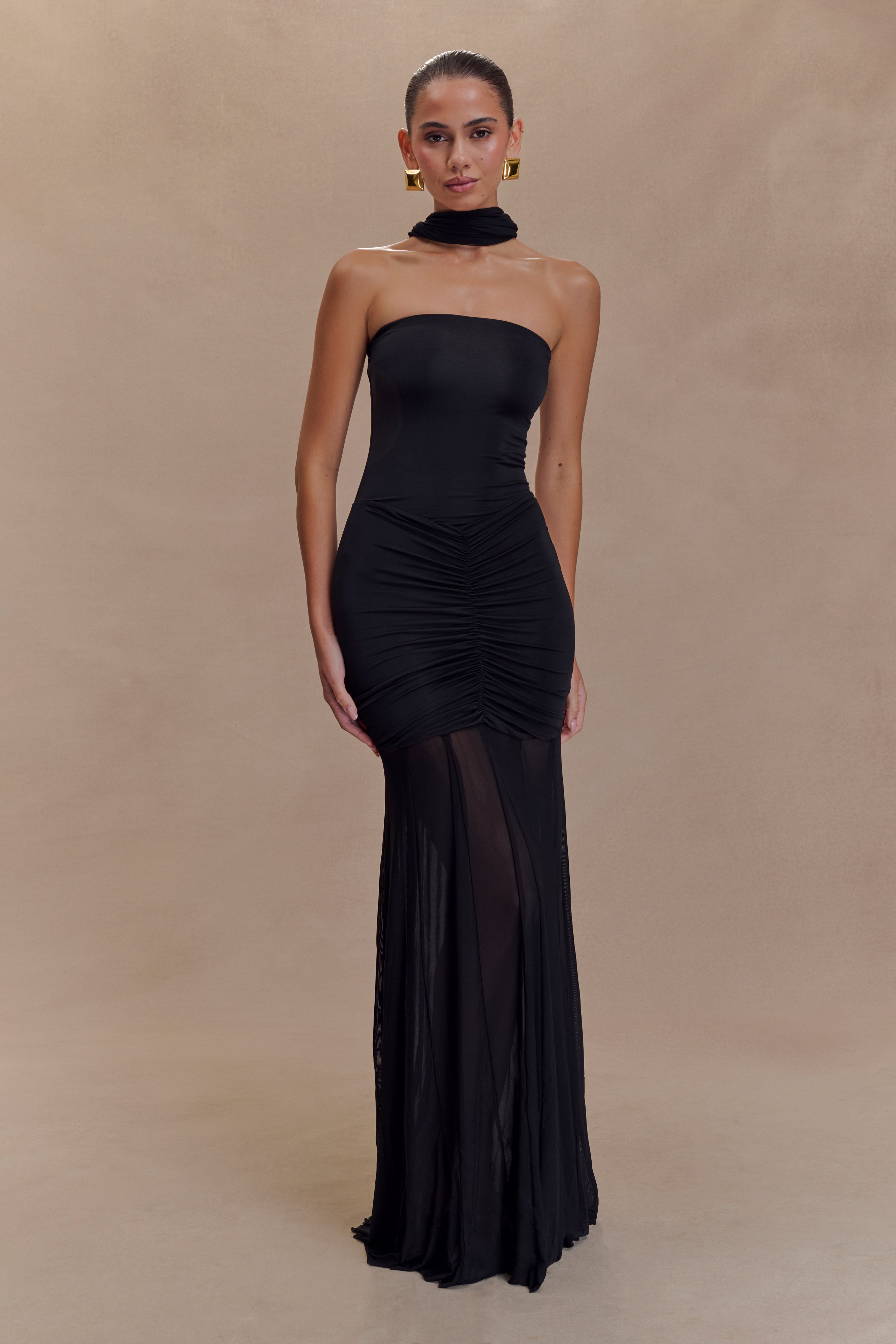 Black strapless ruched bodycon maxi dress with sheer mesh skirt panel