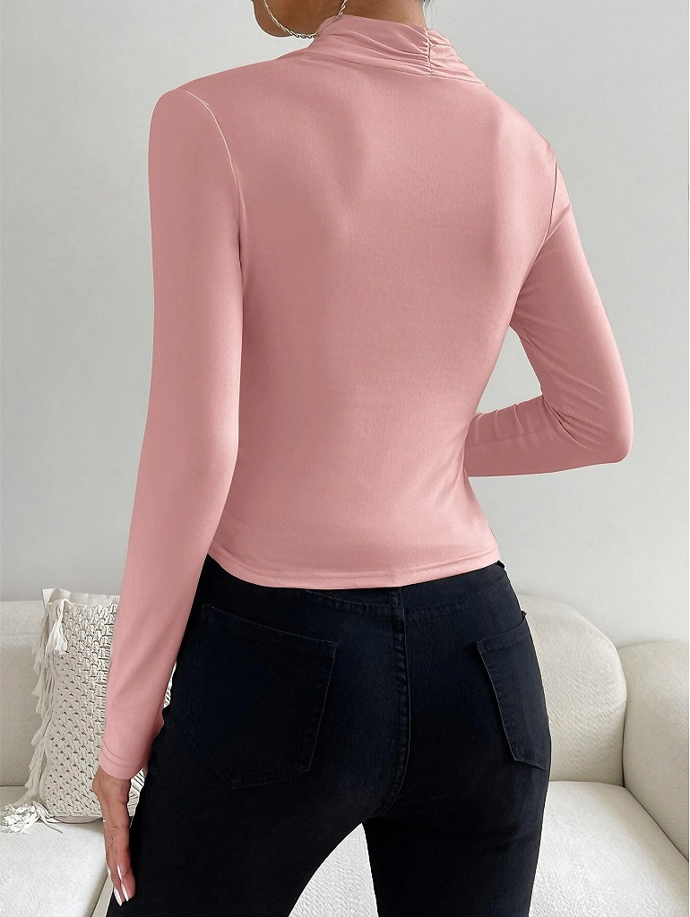 Pink mock-neck long-sleeve top with ruched crossover wrap at waist
