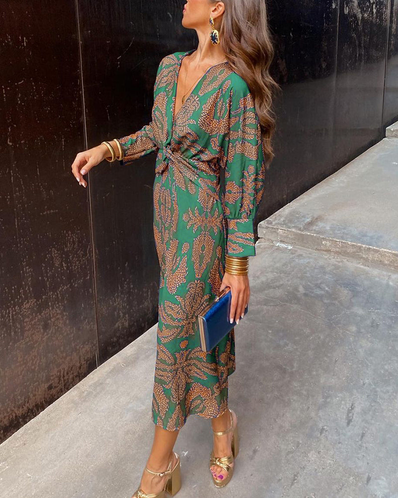 Green viscose midi dress on model, long sleeves, twist-front deep V-neck, botanical print