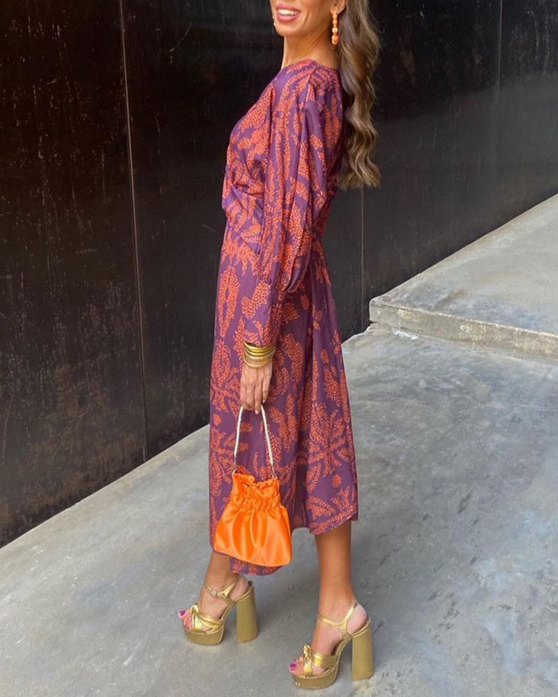 Maroon midi dress with long sleeves and botanical print, twist front, side view