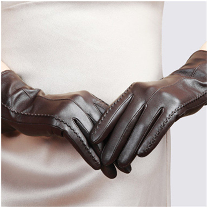 Brown leather women's gloves with stitched seams and snug wrist cuff