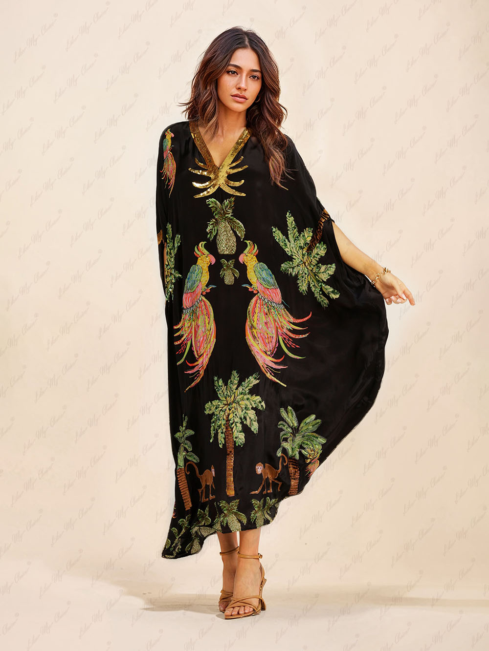Black tropical print kaftan maxi dress with V-neck and gold sequin trim, draped fit.