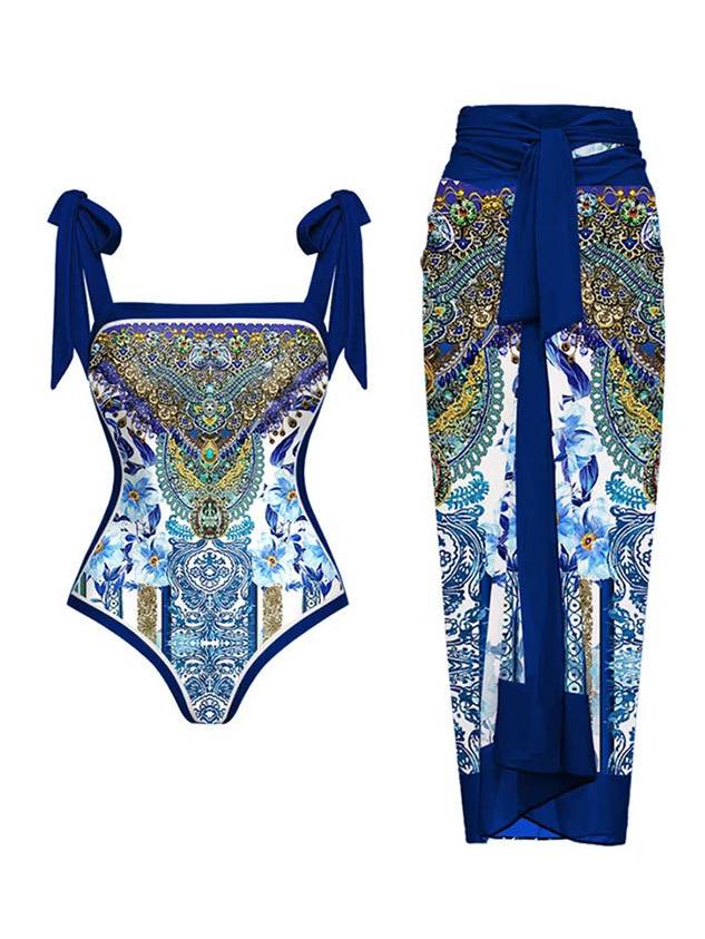 Blue patterned one-piece swimsuit with tie straps; matching wrap sarong with draped panel