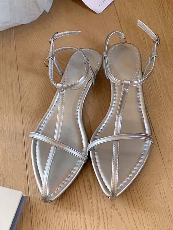 Silver faux leather T-strap flat sandals with pointed toe and adjustable ankle strap