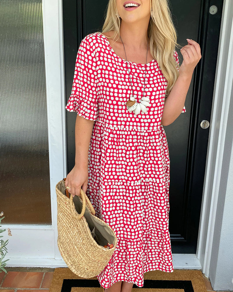 Red polka dot midi dress with smocked waist, flutter sleeves, ruffle hem, white flower