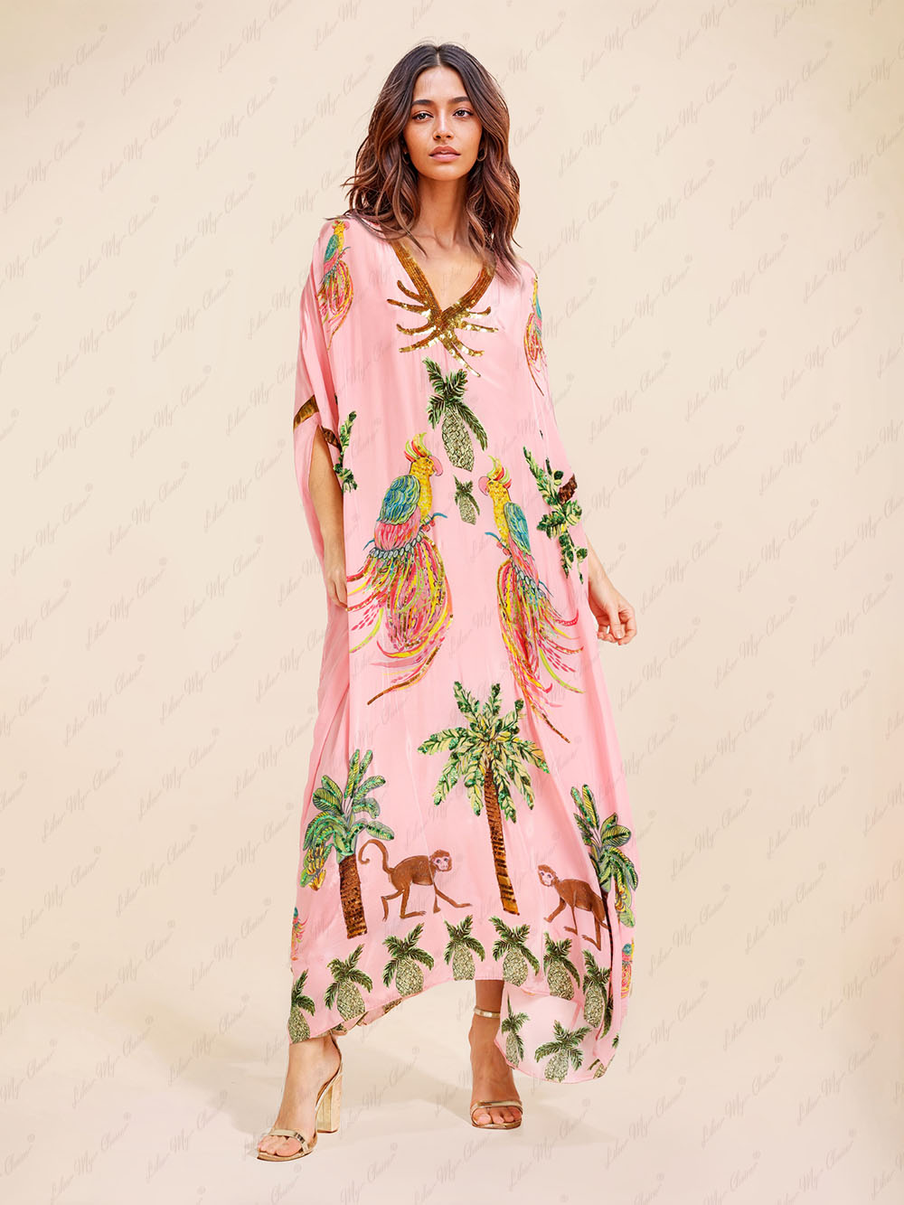 Pink tropical print kaftan maxi dress with V-neck and gold sequin trim, flowing sleeves.