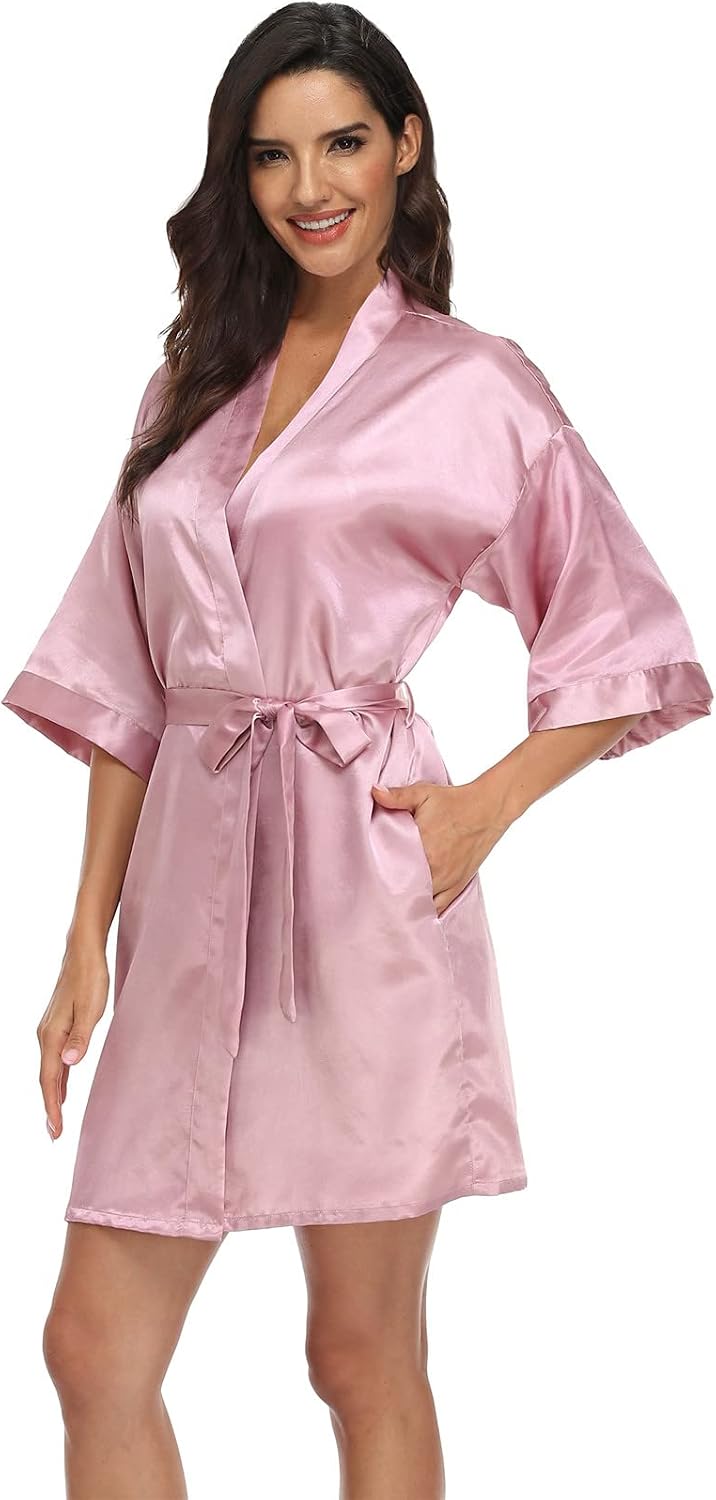 Women's pale pink satin robe with a wrap front, wide sleeves, tie belt and pockets
