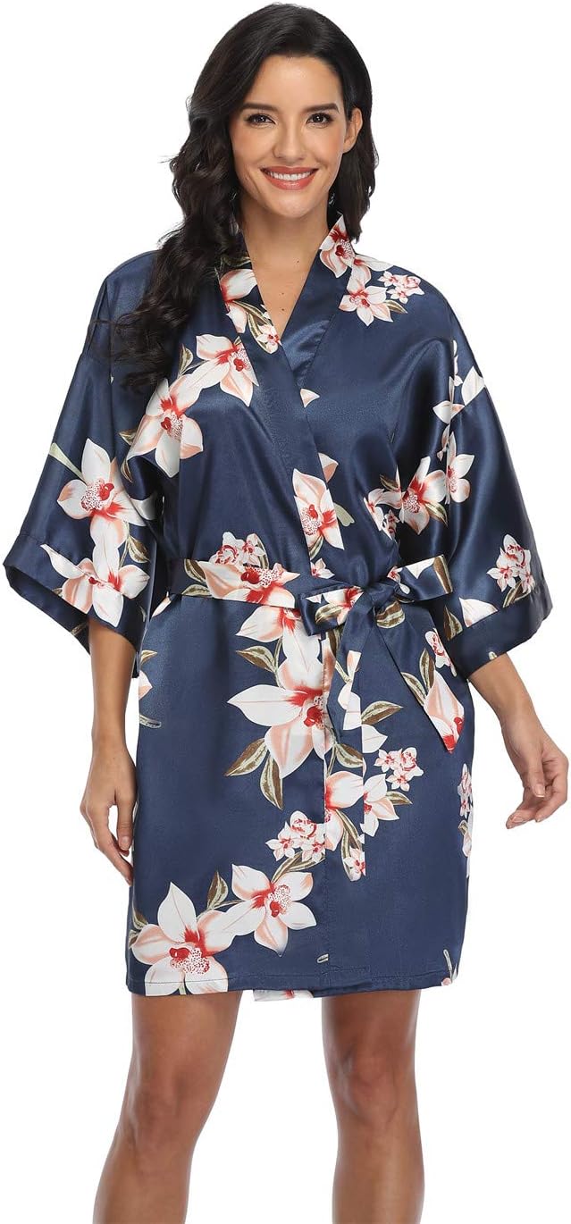 Short navy satin robe with white floral print, wide sleeves, and a matching tie belt