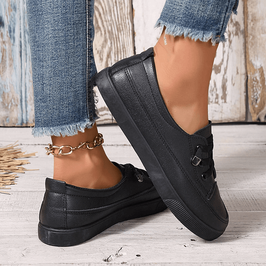 Women’s black chunky platform lace-up sneakers in faux leather, back angle showing thick sole.