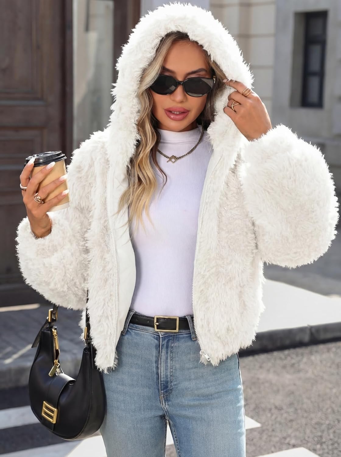 White faux fur cropped coat worn with the hood up