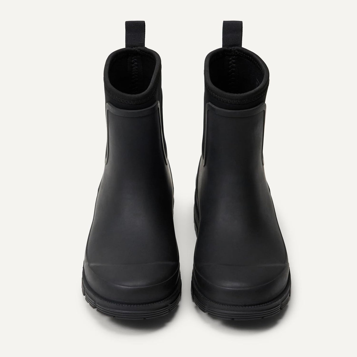 Pair of black Chelsea ankle rain boots shown from the front