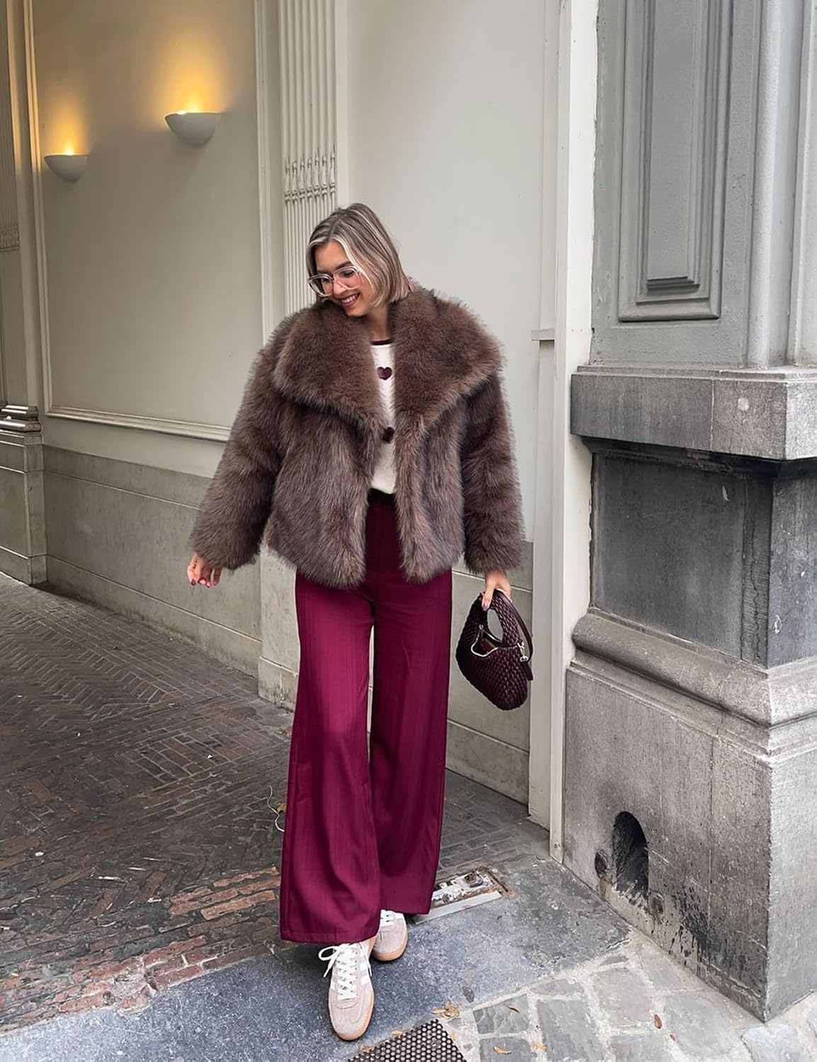 Brown faux fur jacket with wide lapels and button front, worn with long sleeves
