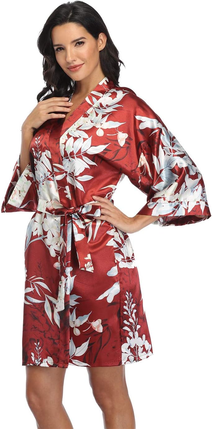 Short red satin robe with a white floral print, wide sleeves and a matching tie belt