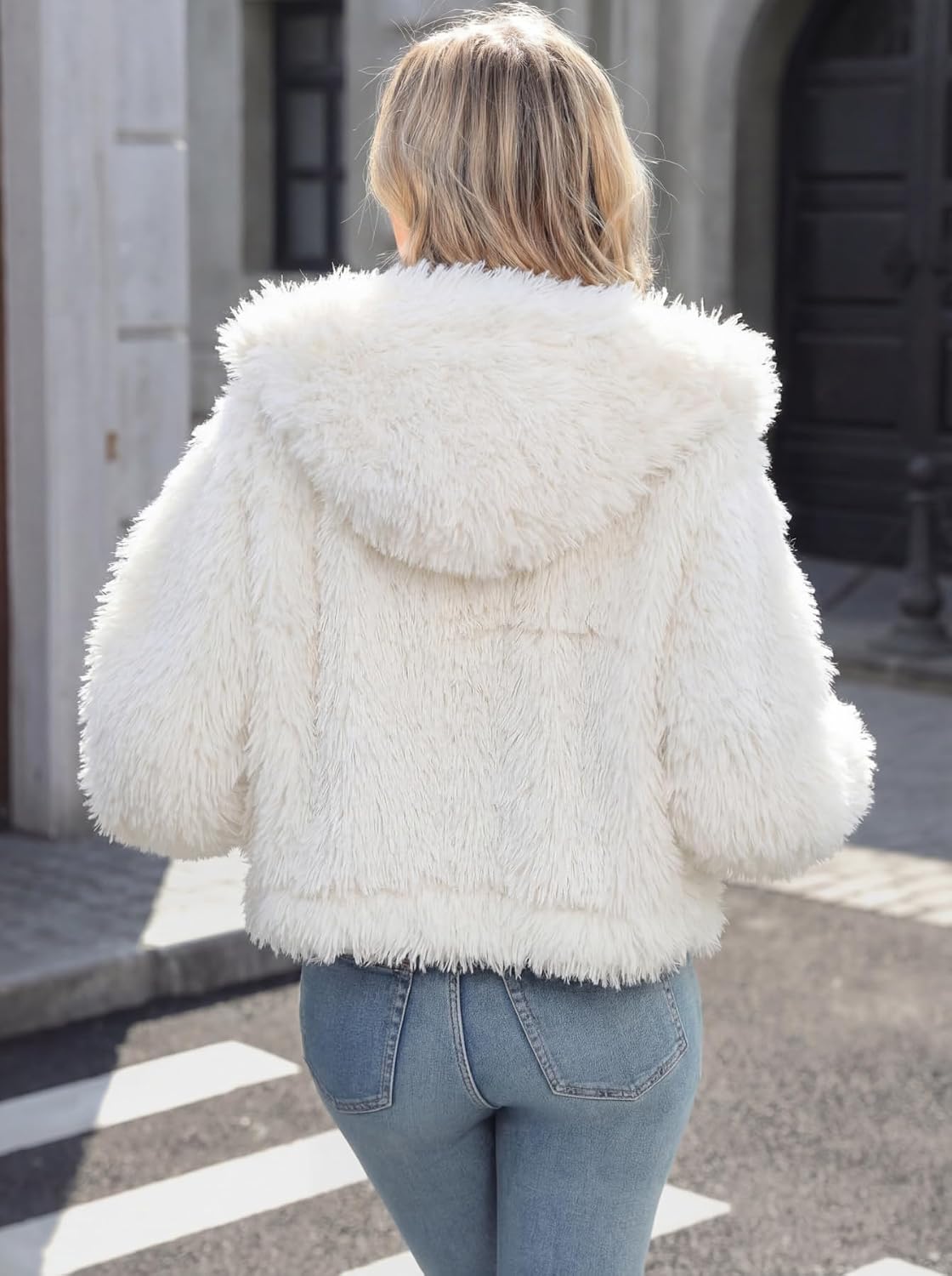 Back view of a white faux fur cropped coat with a large hood