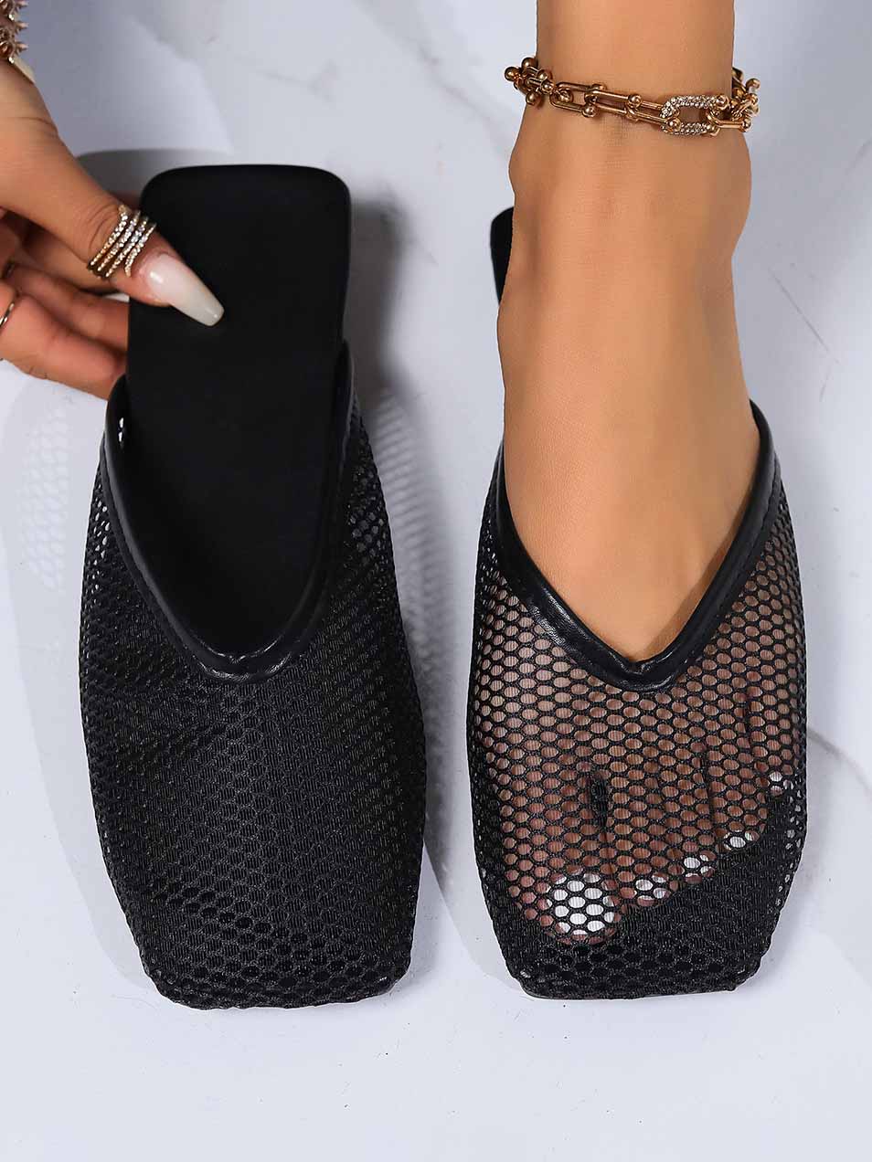 Black mesh mules, flat slip-on with breathable square toe and scalloped topline.