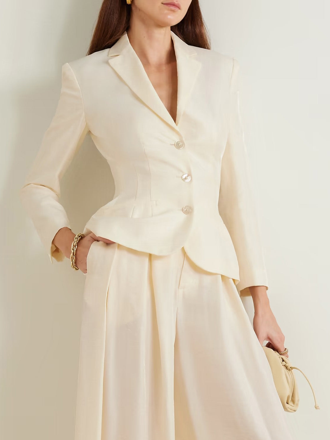 Cream single-breasted tailored blazer with notch lapels and structured shoulders