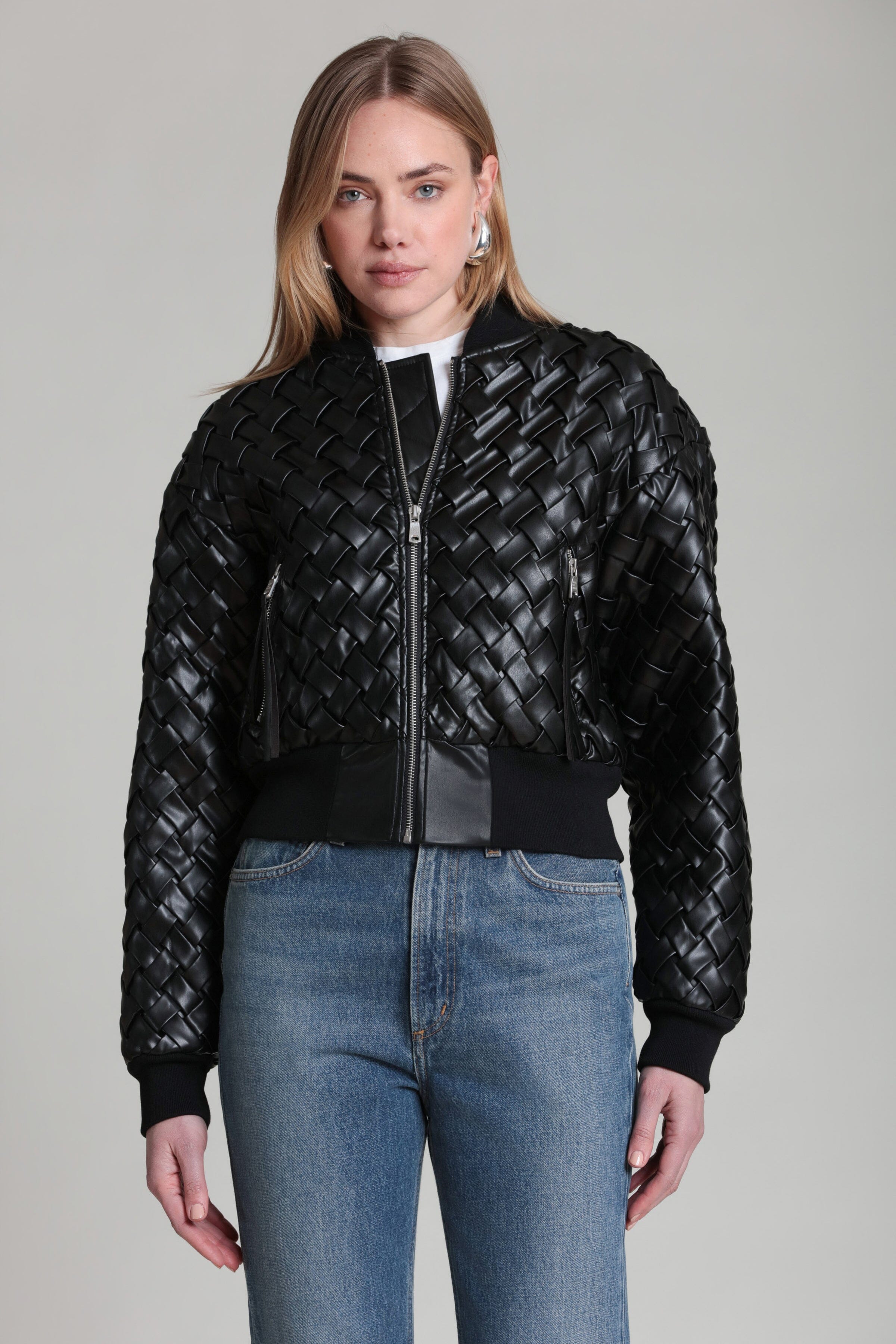 Black bomber jacket with quilted woven texture, full front zipper, ribbed hem