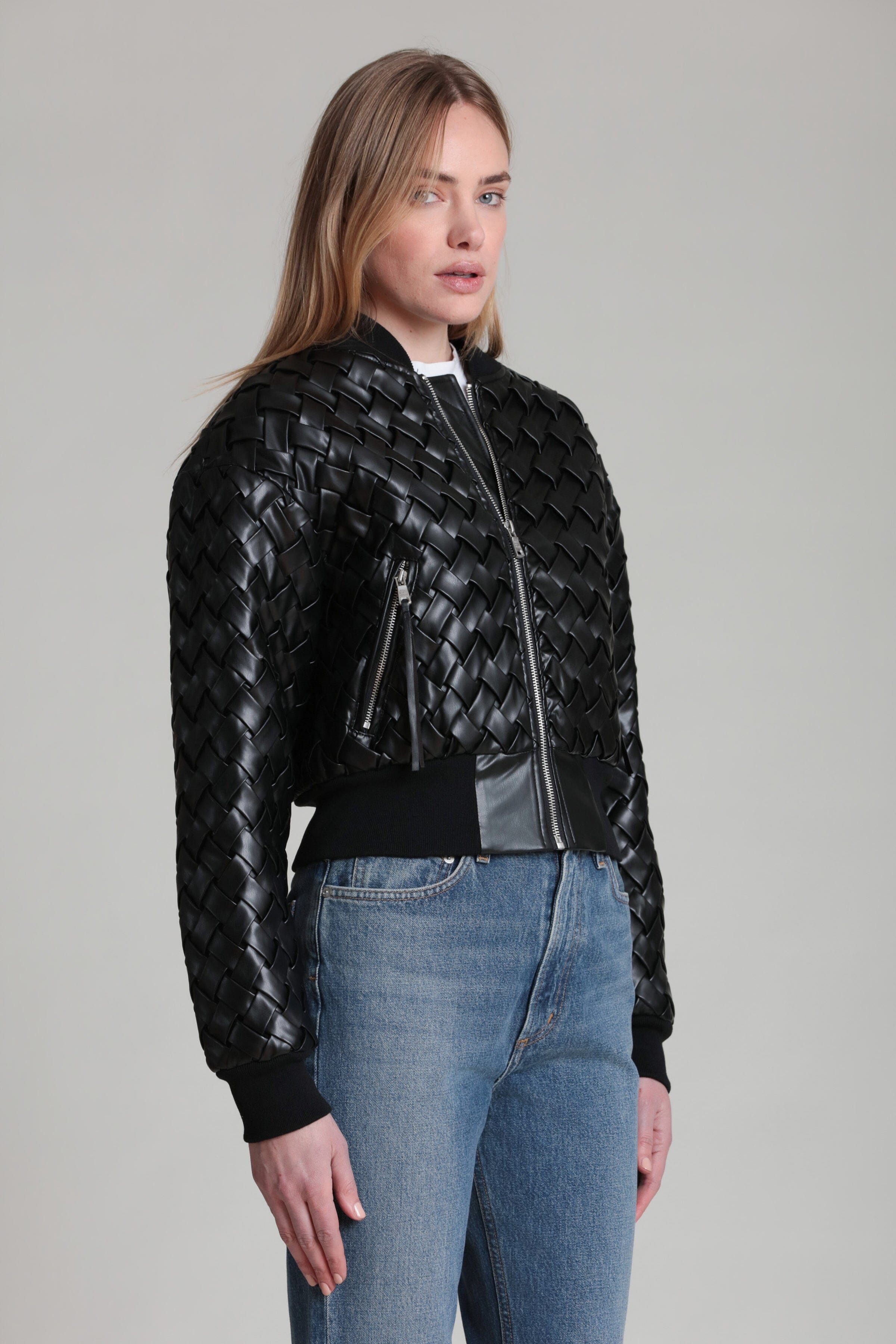 Black woven bomber jacket with diagonal zipper placket and ribbed cuffs