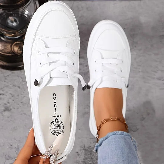 Women’s white chunky platform lace-up sneakers, front view; thick sole and faux leather upper.