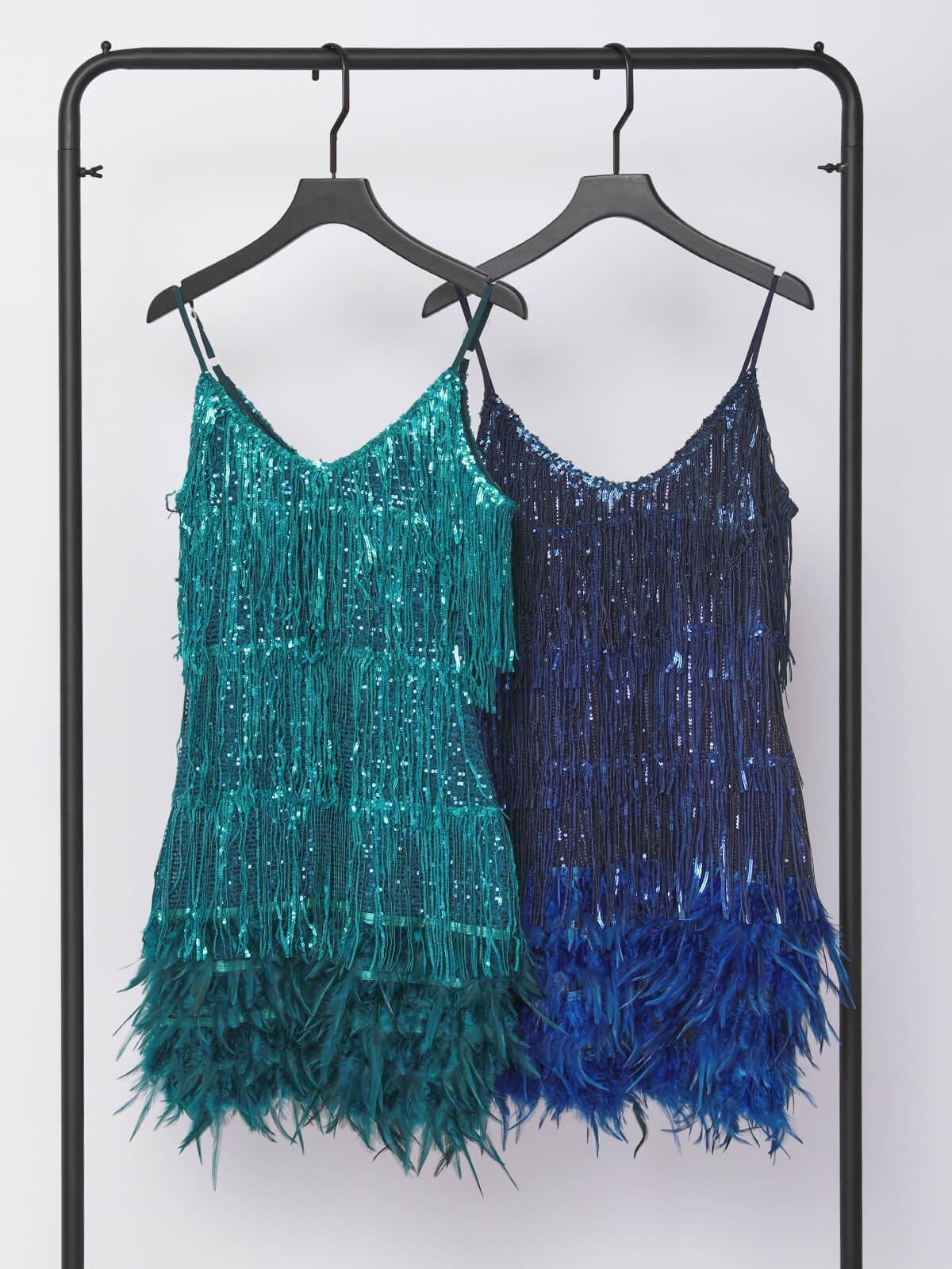 Blue and dark-blue sequin fringe mini dresses on hangers with feather hem