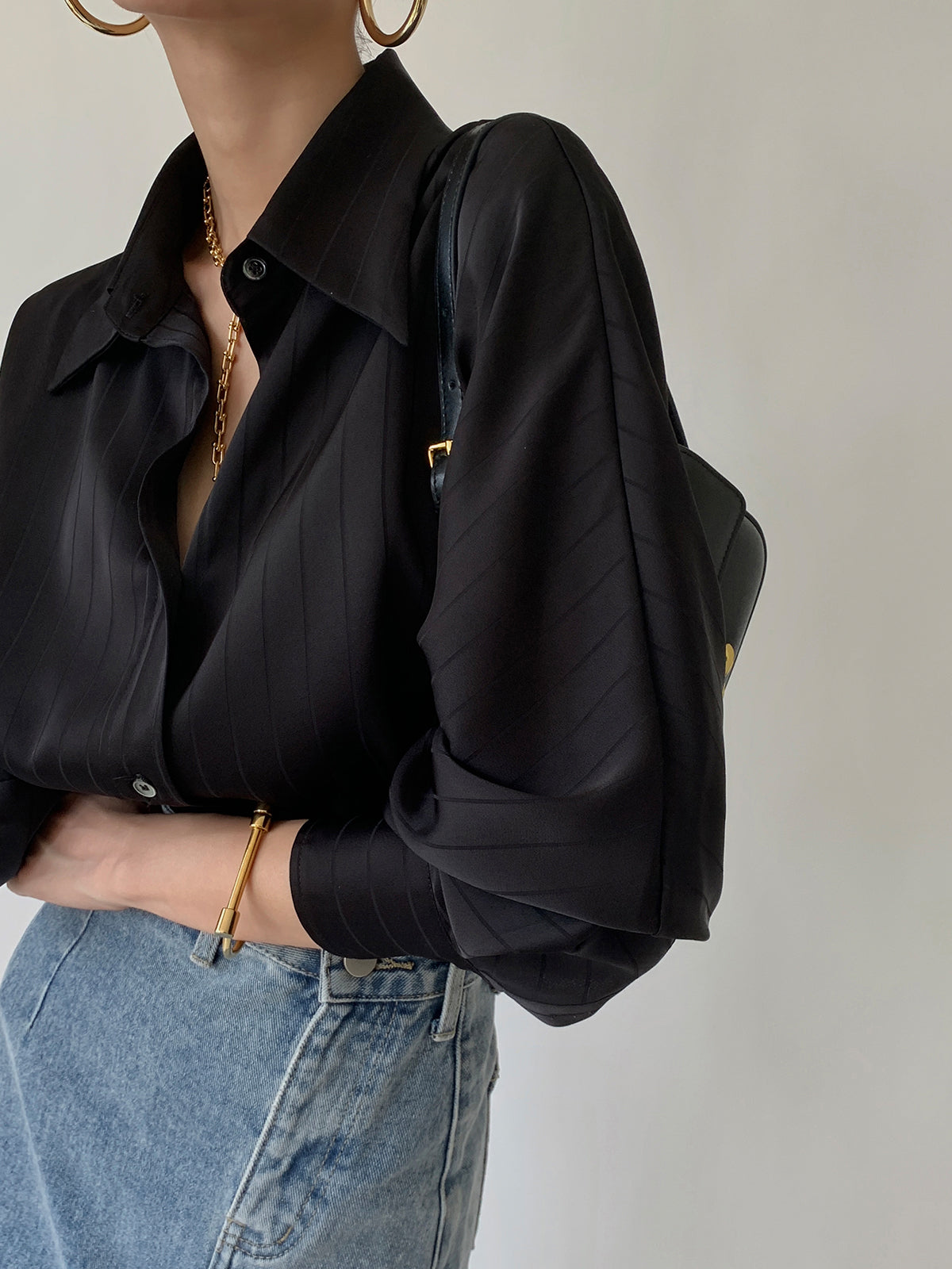 Black satin oversized button-front blouse with tonal vertical stripe, long sleeves