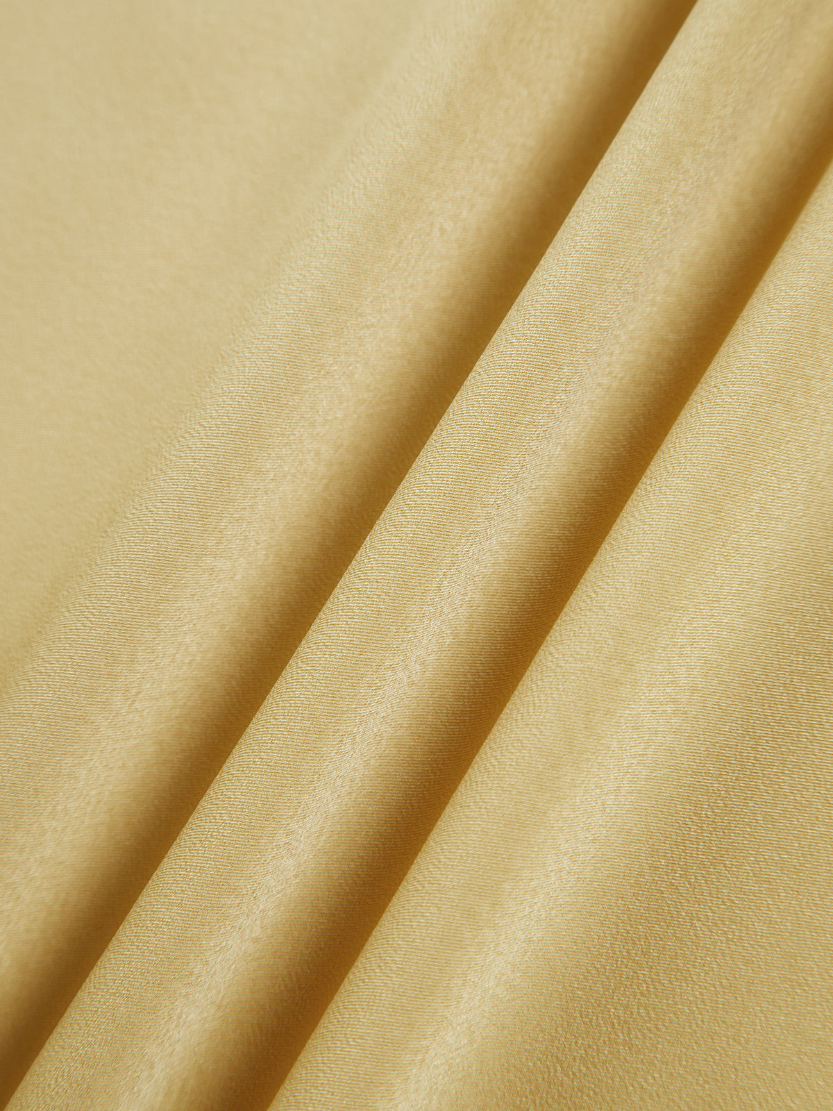 Yellow satin fabric close-up with smooth sheen and fluid drape