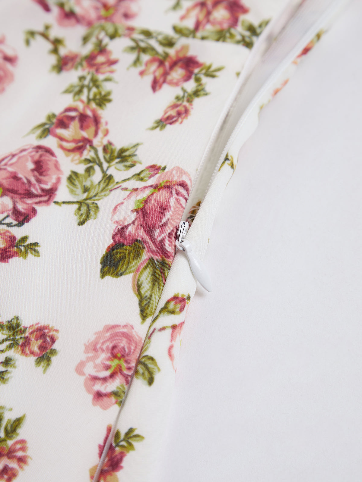 Pink floral cotton fabric closeup showing back tie detail and eyelets