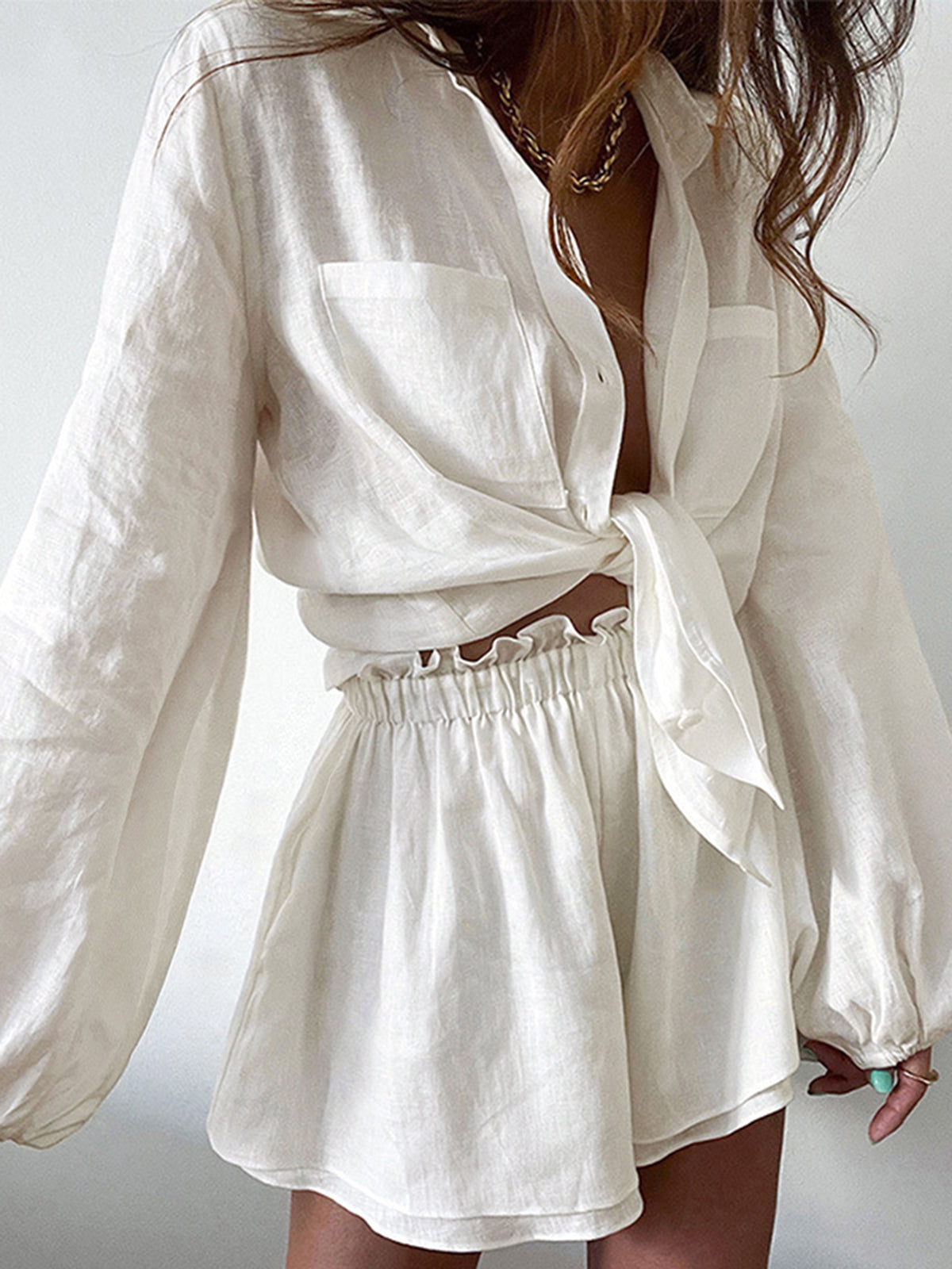 White linen oversized button shirt with elastic-waist ruffled shorts
