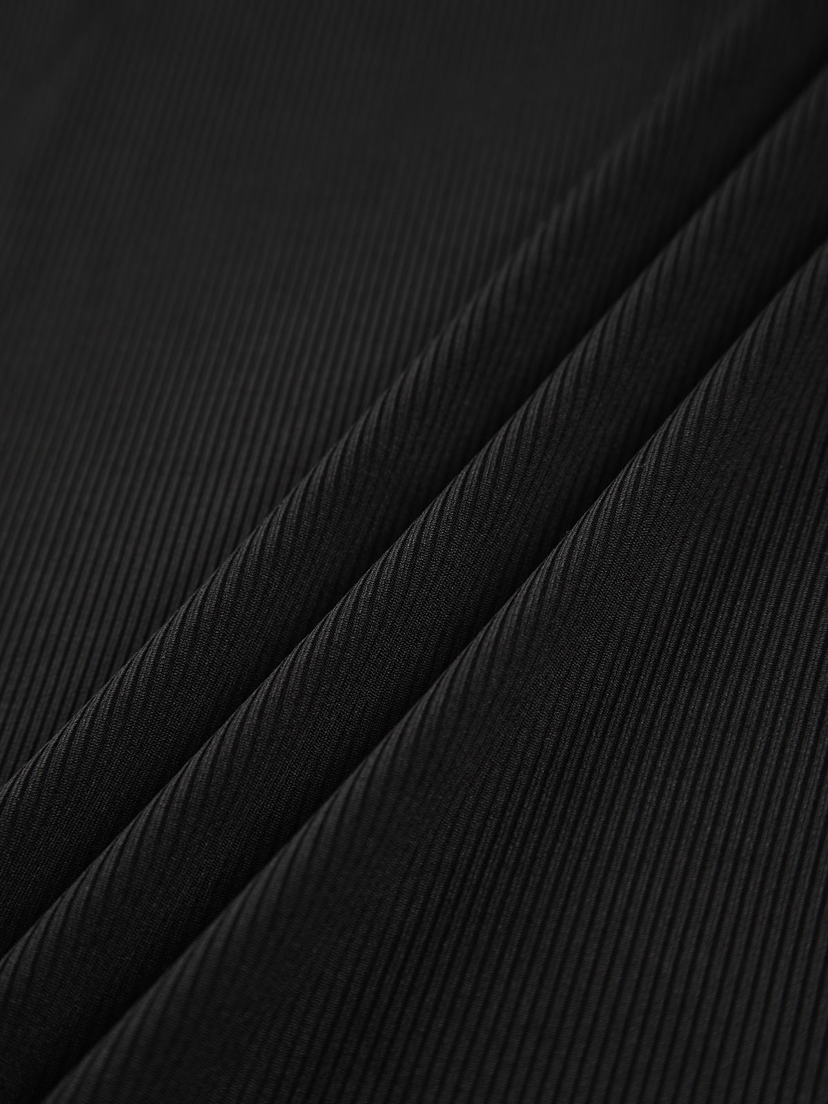 Black ribbed knit fabric texture close-up for long-sleeve top