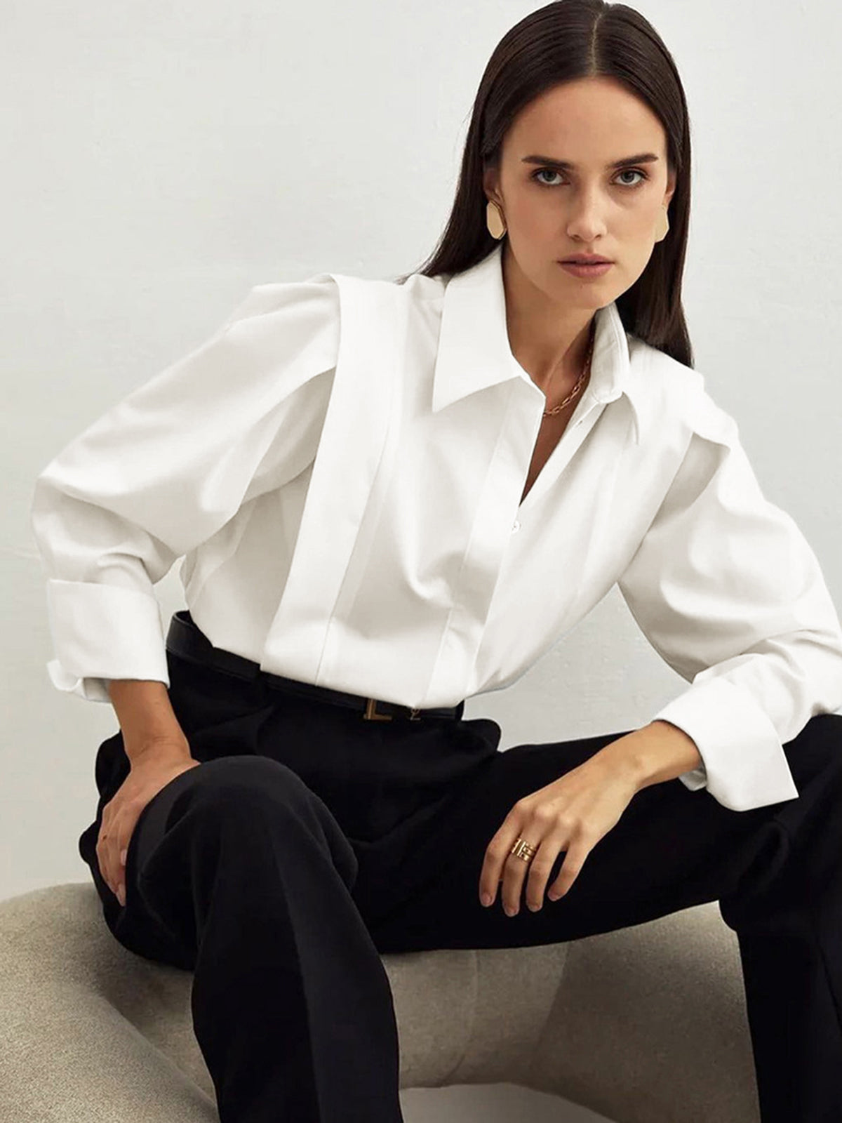 White cotton oversized button-down blouse with structured power shoulders, open collar
