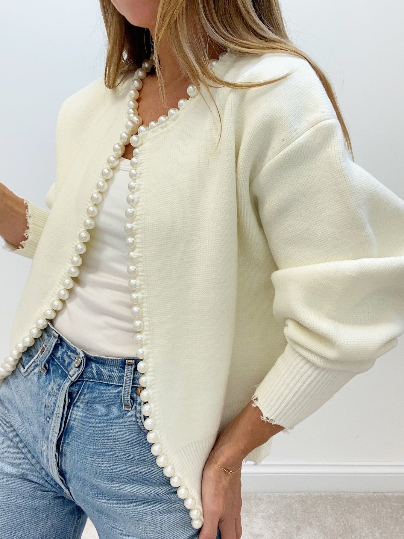 Women’s cream cardigan with open front, long pearl trim edging, relaxed sleeves