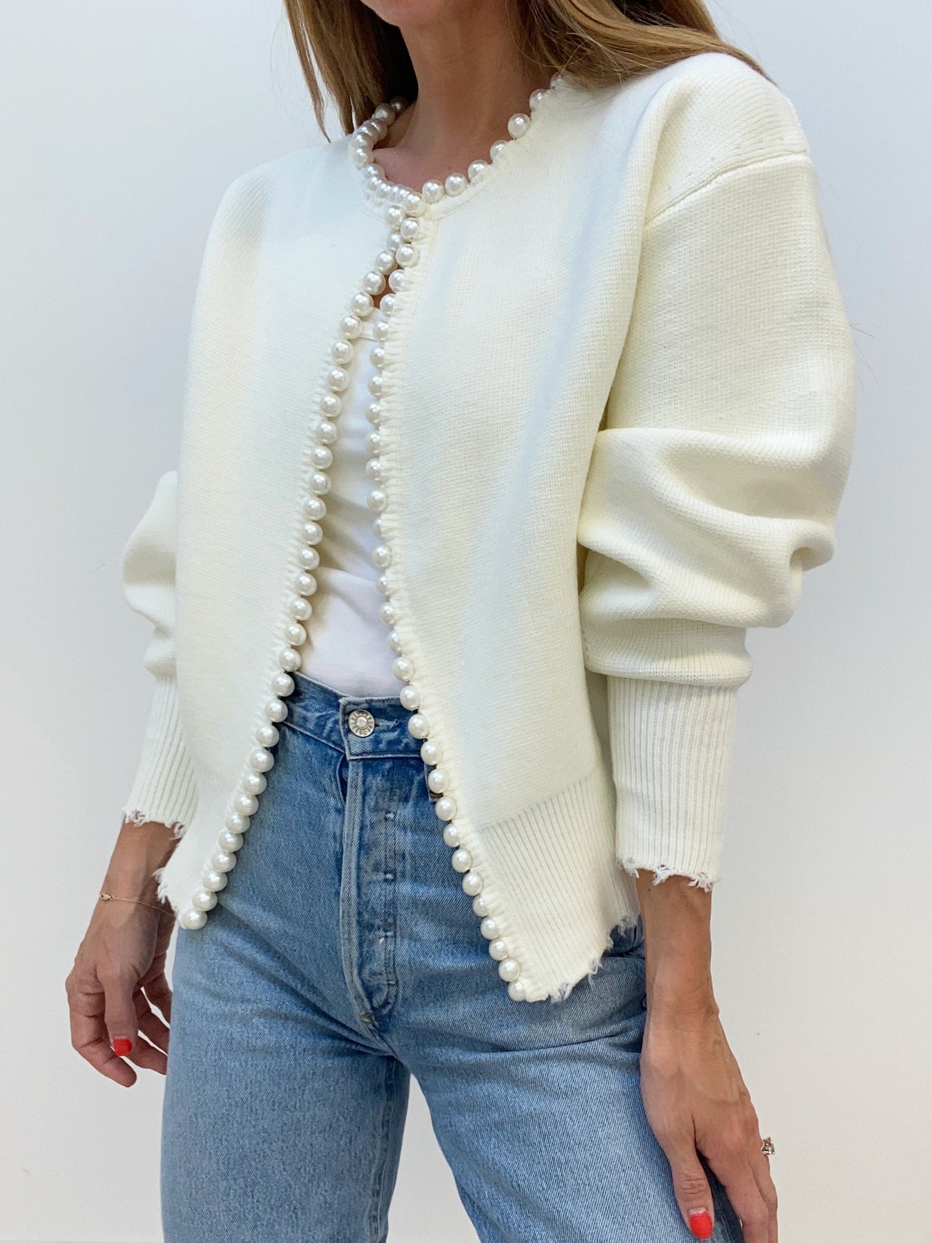 Women’s cream knit cardigan with open front and pearl button trim, relaxed fit