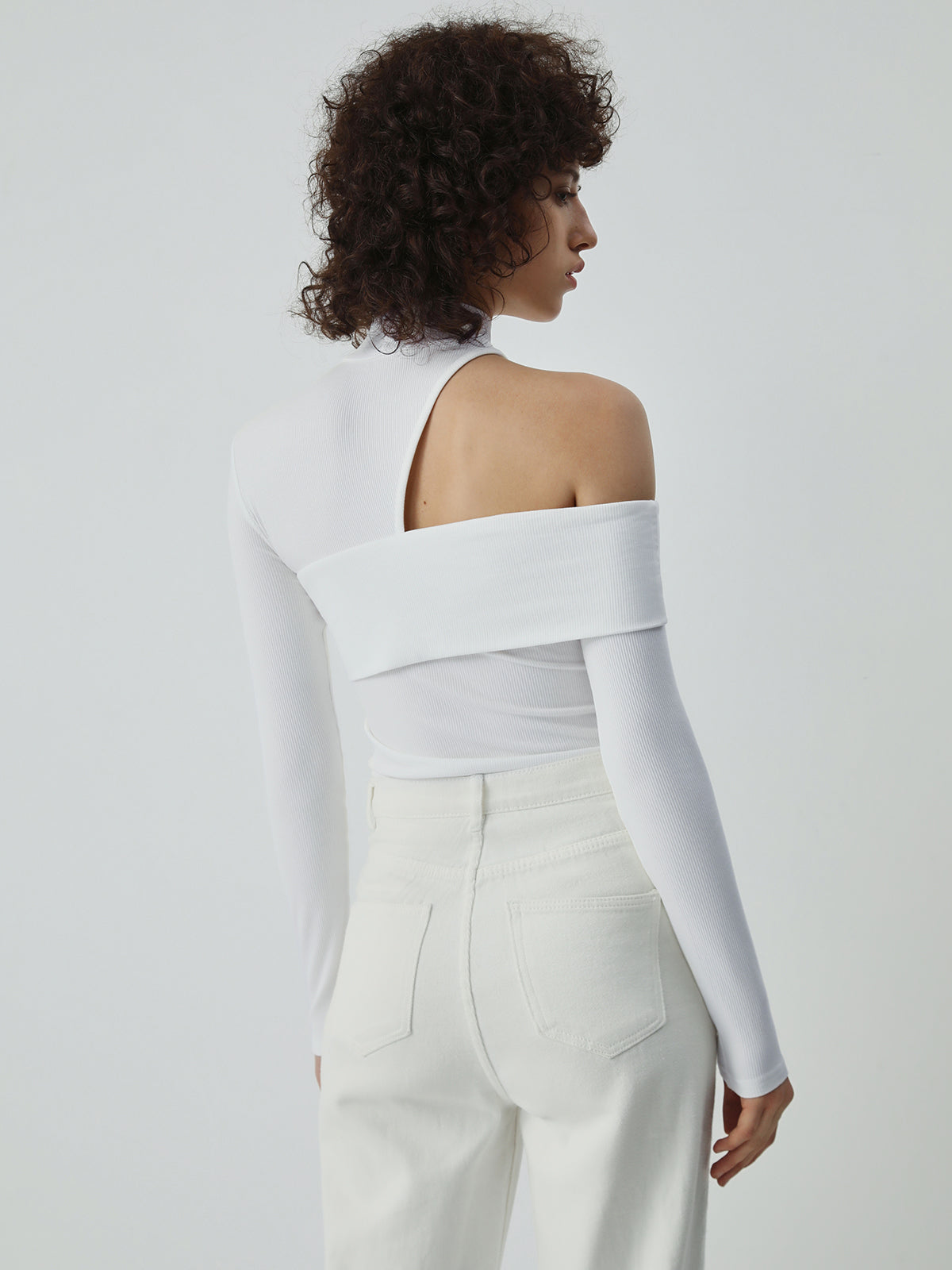 White ribbed turtleneck top with asymmetric cut-out back shoulder detail